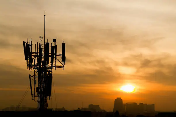 Mobile phone Telecommunication Radio antenna Tower. Cell phone tower with sunset sky, silhouette