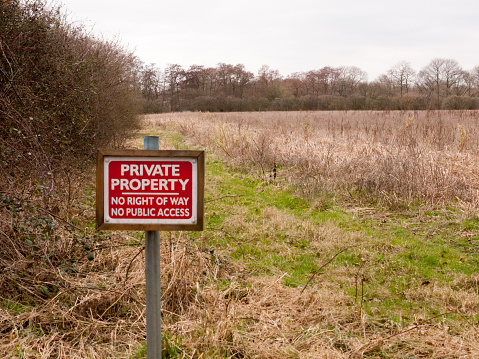 red wooden private property sign farm land no right of way no public access; essex; england; uk