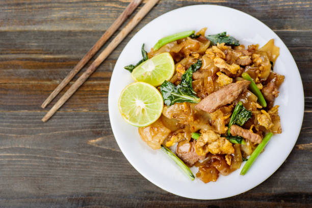 istock Thai food, stir fried rice noodle in soy sauce (Pad See Ew) 939349638