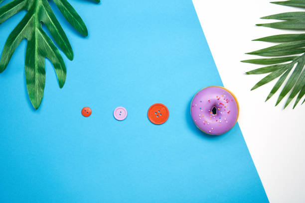 Purple donut and colorful on a blue background. creative food minimalism, Concept candy shop.