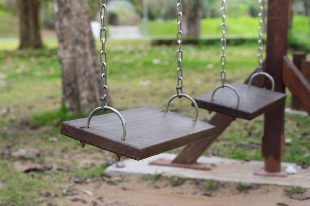 istock Wooden old swings in playground 939356076