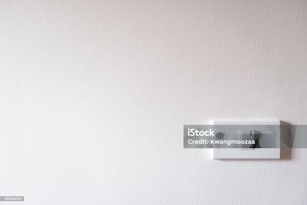 light switch on white concrete wall room light switch on white concrete wall Dimmer Switch Stock Photo