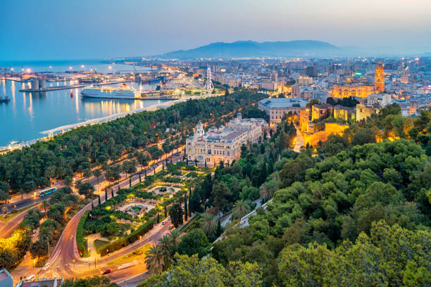 Cityscape of Malaga Andalusia Spain Cityscape stock photograph of Malaga Andalusia Spain with the city hall, cathedral, downtown park and harbor, as seen at twilight. alcazaba of málaga stock pictures, royalty-free photos & images