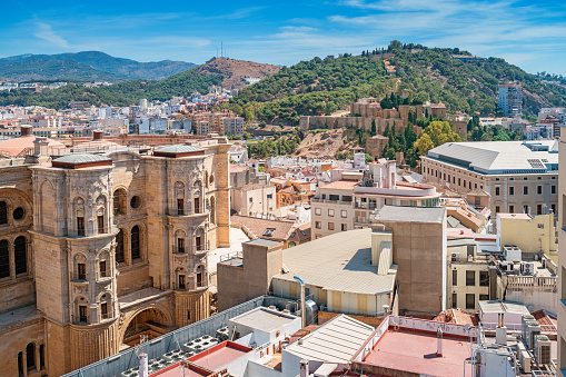 Cityscape stock photograph of Malaga Spain with the Cathedral and the landmark hill with the Alcazaba.