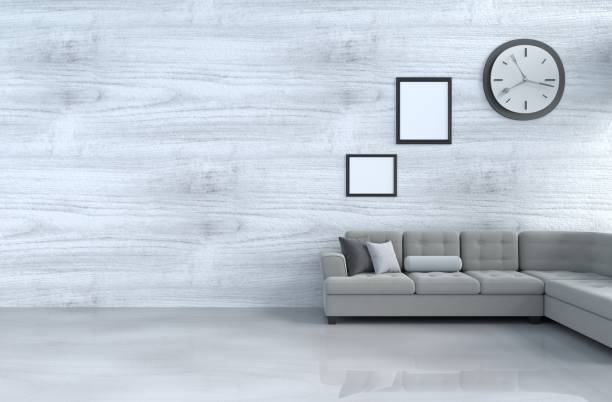 istock Grey-White living room decor with grey sofa, wall clock, white wood wall, window, book, pillow grey white cement floor, picture frame. The sun shines through the window into the shadows. 3d rendering. 939376856