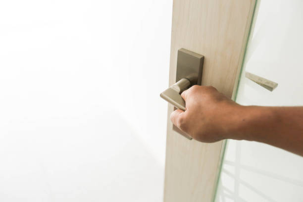 istock One man holds the door handle and opens the door 939383198