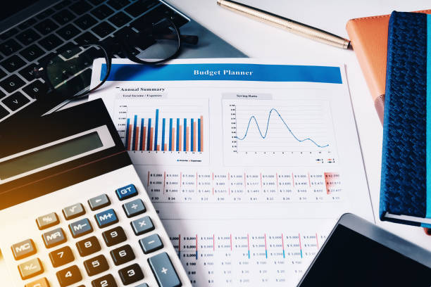 istock Budget concept, budget planner paper, calculator, computer laptop, notebook and smart phone on the table. 939384706