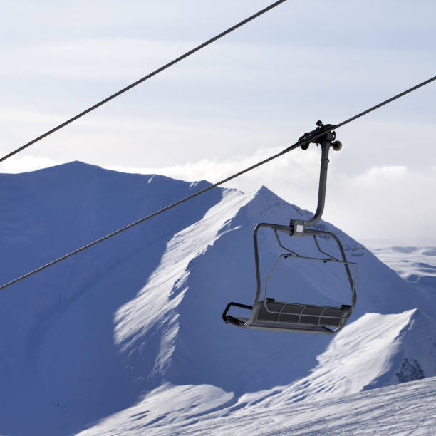 istock Chair lift and mountains in evening 939384892