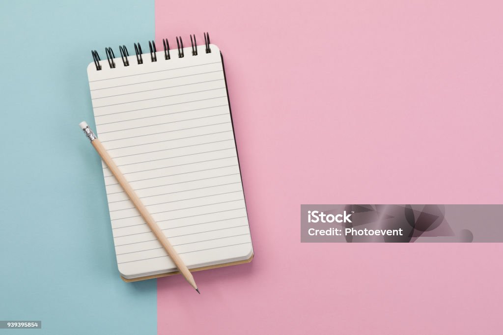 Shoppinglist - Concept Spiral Notebook on blue and pin background Note Pad Stock Photo