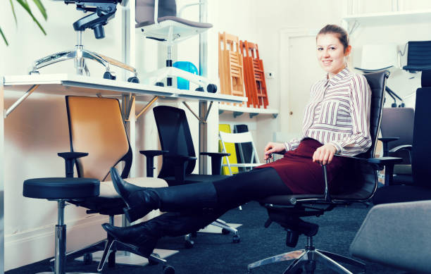 istock Young woman testing new chairs in salon 939399492