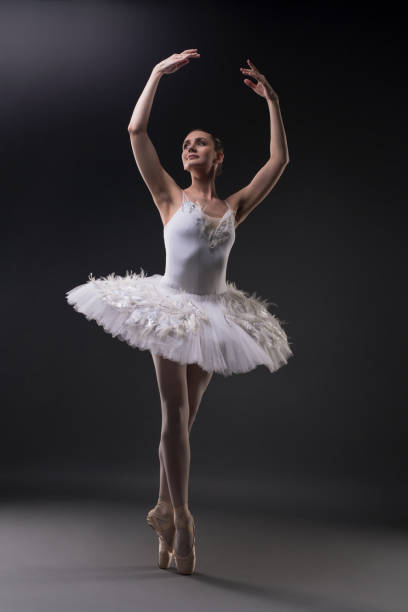 istock Ballerina dancing gracefully in the dark 939410112