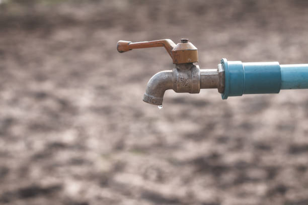 istock Water droplets on arid soil, Concept drought and crisis environment. 939410138