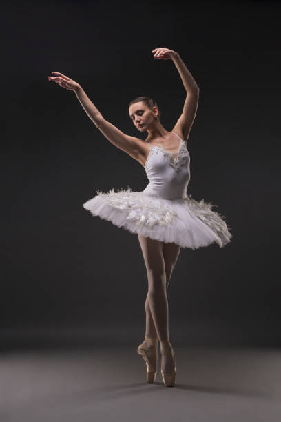 istock Beautiful ballerina dancing gracefully in the dark 939410152