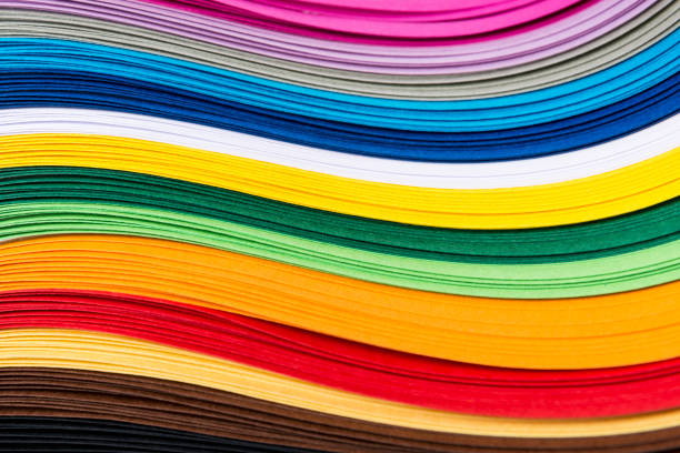 Multicolored quilling paper curved stripes forming a bright background.