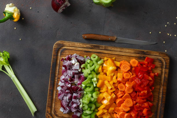 istock Top view sliced fresh vegetables serving on cutting board on dark background 939423682