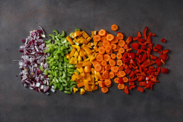 Flat lay sliced fresh vegetables on dark background. Top view
