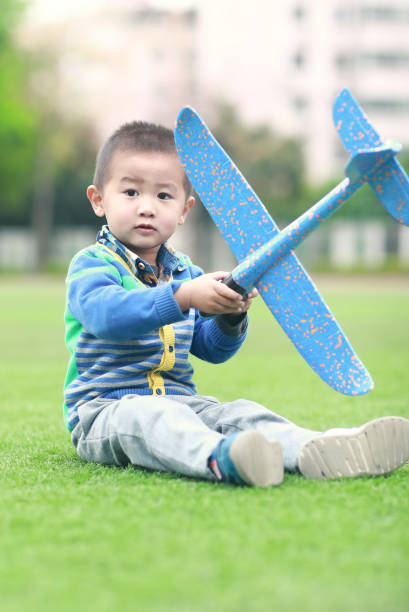 istock Child hand holding a paper plane 939424074