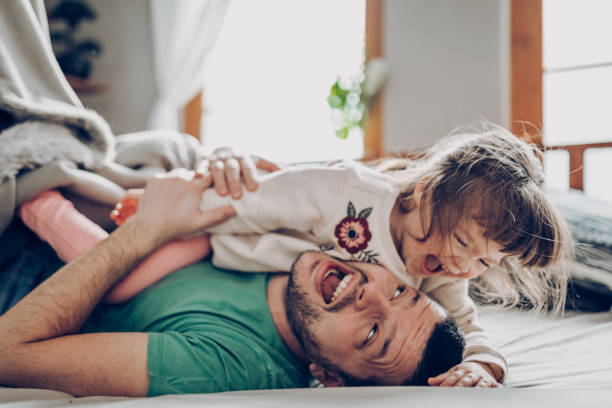 Under the blanket Father playing with his daughter children laughing stock pictures, royalty-free photos & images