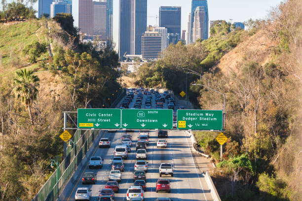 istock Los Angeles skyline with freeway traffic and signs 939443846
