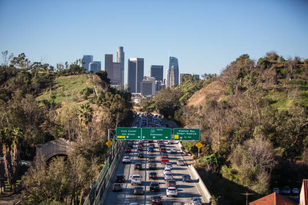 istock Los Angeles skyline with freeway traffic and signs 939443870