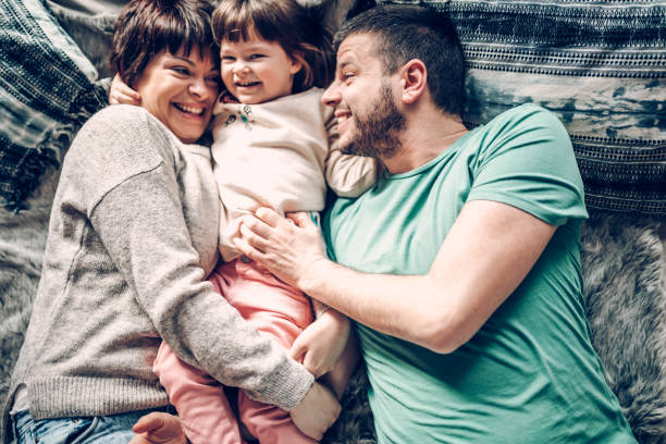 istock Happy family in bed room having fun 939447232