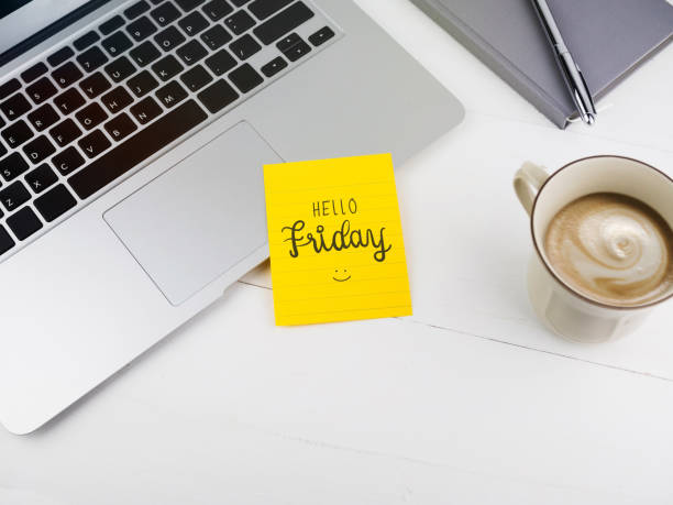 Hello Friday with smiley icon face on sticky note on desk Hello Friday with smiley icon face on sticky note on desk office fun business adhesive note stock pictures, royalty-free photos & images