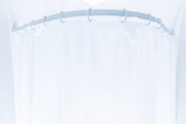istock White plastic shower curtain in white bathroom 939449736