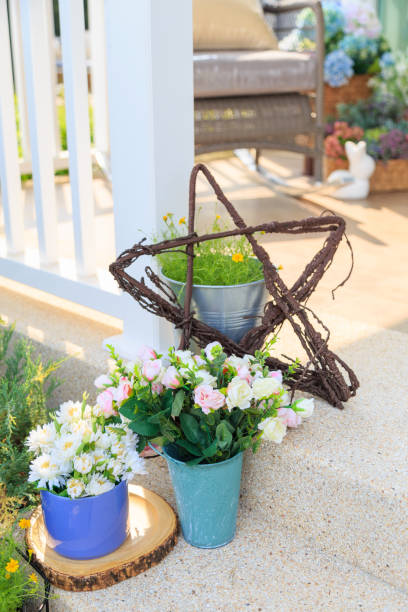istock An artificial flowers in blue pot on floor in a porch. 939450890