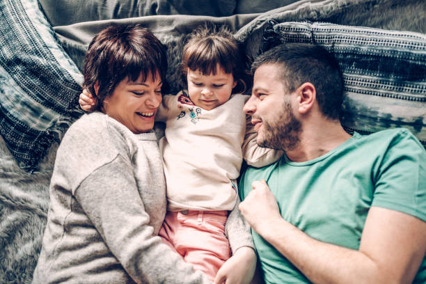 istock Happy family in bed room having fun 939453366