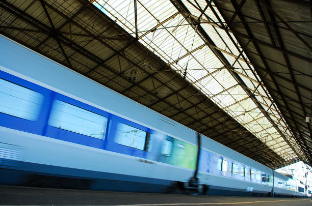 istock Train and wagons crossing a railway station 939454190