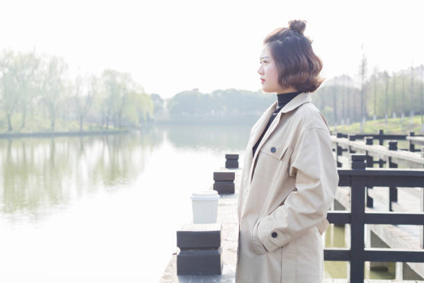 istock young woman relaxing at park footbridge 939457396