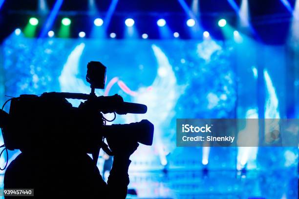 Professional Video Camera Operator Working With His Equipment Blue Background Stock Photo - Download Image Now