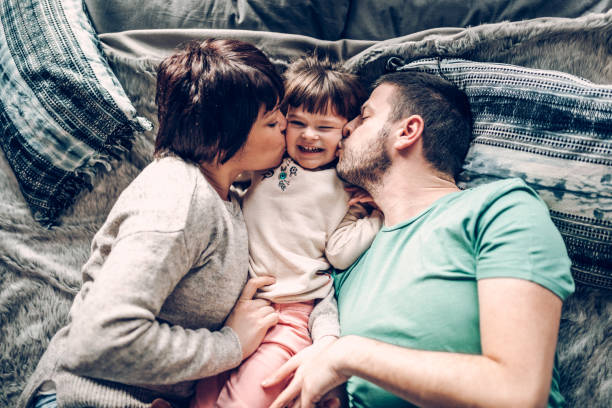 istock Happy family in bed room having fun 939457658