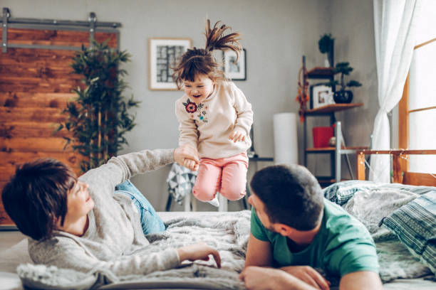 istock Happy family in bed room having fun 939457718