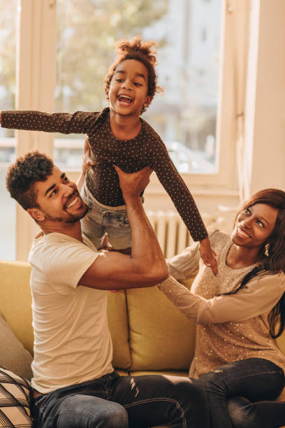 istock Playful black family having fun while spending their time together at home. 939463838