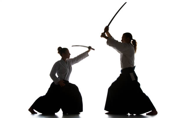 istock Man and woman fighting and training aikido on white studio background 939468088