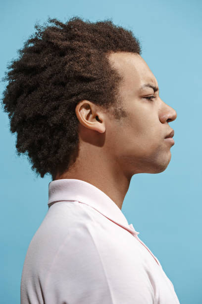 istock Beautiful bored afro man isolated on blue background 939471972