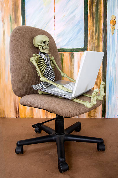istock Worked to Death  Skeleton in office chair with computer. 93947537