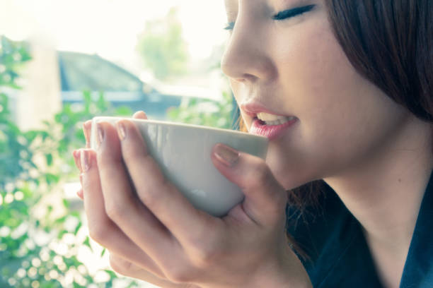 istock woman smell coffee 939477390