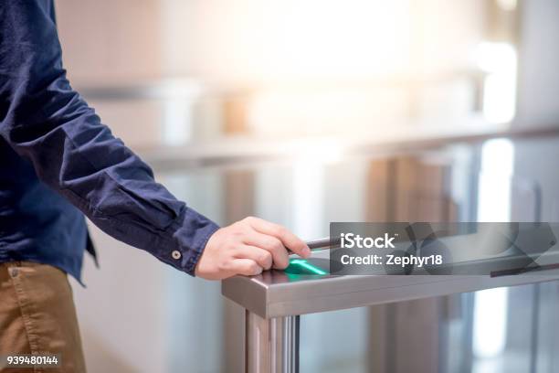 Male Hand Using Smartphone To Open Automatic Gate Machine In Office Building Stock Photo - Download Image Now