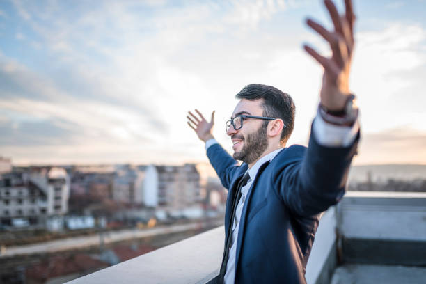istock Office person enjoying life on office building roof 939482048