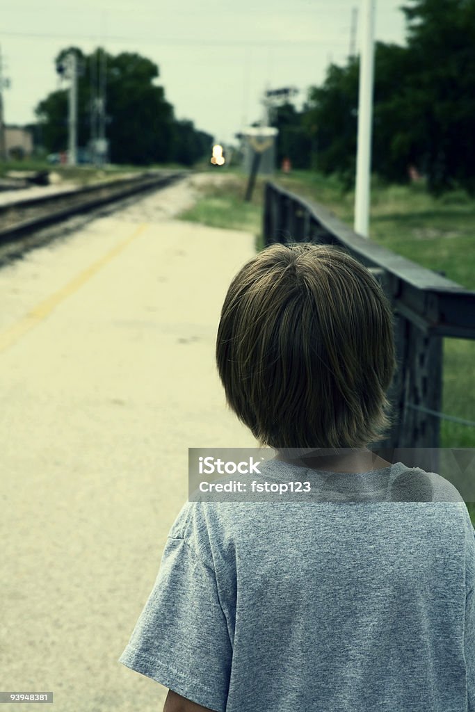 Watching the train arrive Young boy watching the training coming up the track.  He wants to ride. 6-7 Years Stock Photo