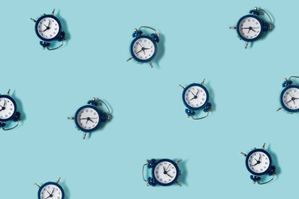 istock Flat lay retro beautiful new alarm clock on blue color background. Pattern. Top 939483966