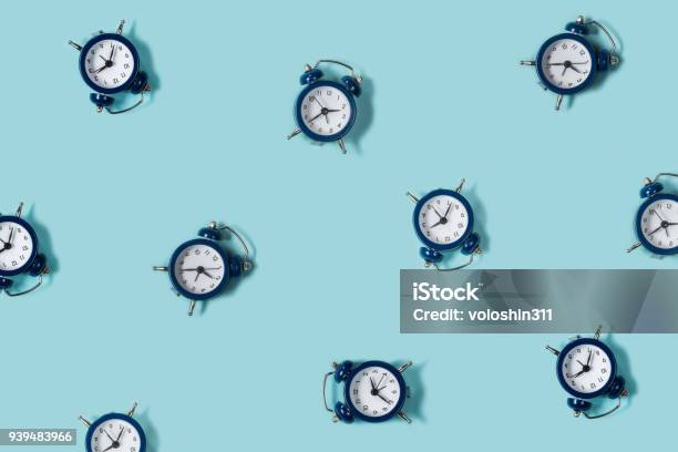 Flat Lay Retro Beautiful New Alarm Clock On Blue Color Background Pattern Top Stock Photo - Download Image Now