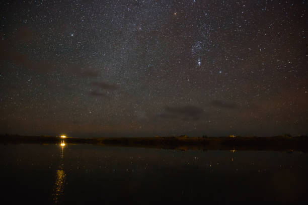 istock illuminated building reflected in water and majestic starry sky at night, iceland 939485630
