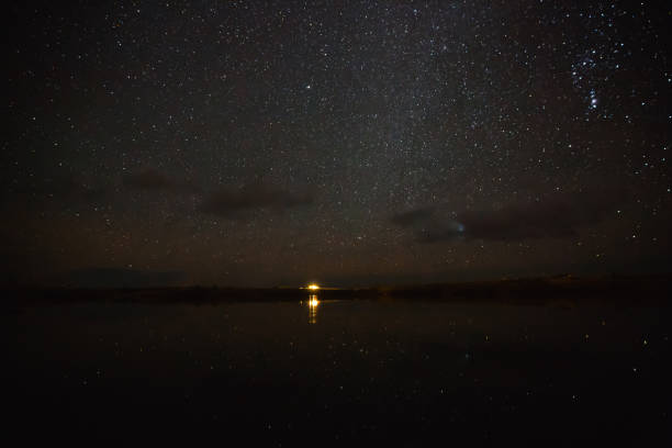istock illuminated building reflected in water and spectacular starry sky at night, iceland 939493464