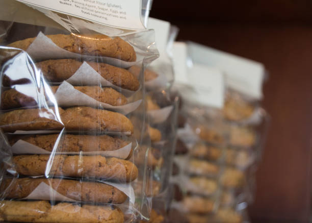 close up of homemade biscuits packaged in cellophane packets on a shelf - packaged food imagens e fotografias de stock