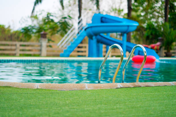 swimming pool with blur of water slide background stock photo