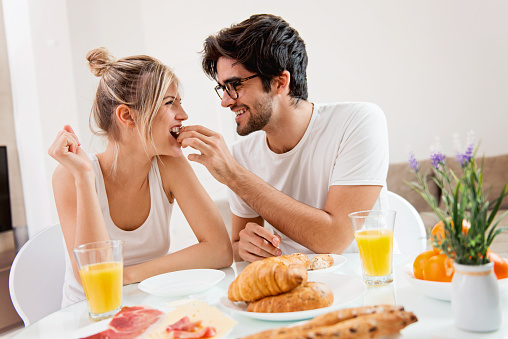 Cute young couple enjoying their breakfast together