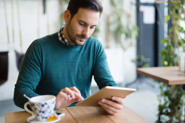 istock Portrait of young attractive man using tablet 939501922